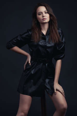 Young brunette girl poses in style clothesの写真素材