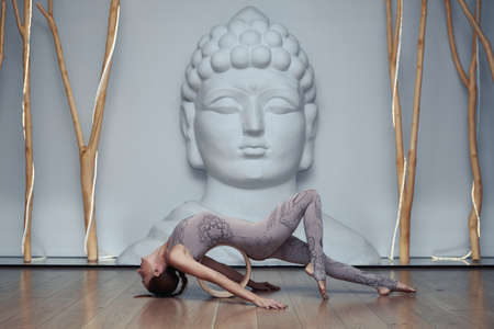 Young Woman Doing Yoga Exercise in Studioの写真素材