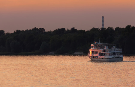 View on the Drepr river and cityscape at evening with barges, ships at sunset in Kiev, Ukraineの写真素材