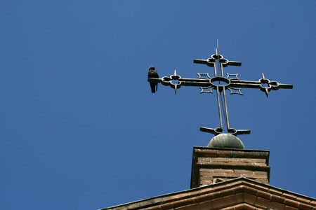 crucifix and birds on blue skyの写真素材