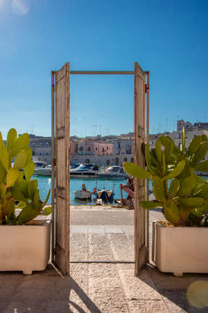 Open door to the sea with a view of the portの写真素材