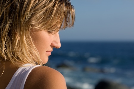 Thoughtful look beautiful young woman. Sea.の写真素材