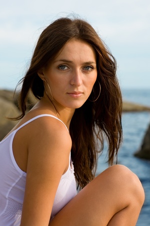 Beautiful young brunette woman at the sea.の写真素材