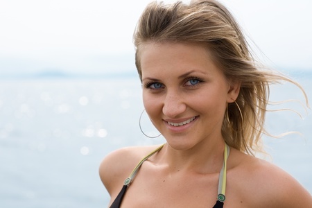 Portrait of a beautiful girl against the sea.の写真素材