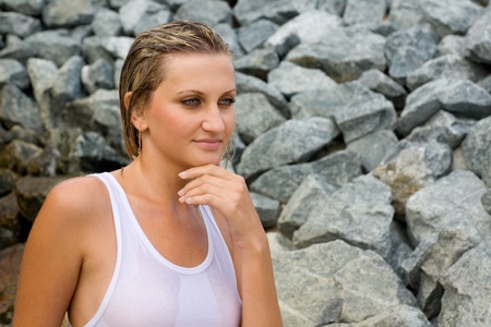 Young sexy woman on a background of stones.の写真素材