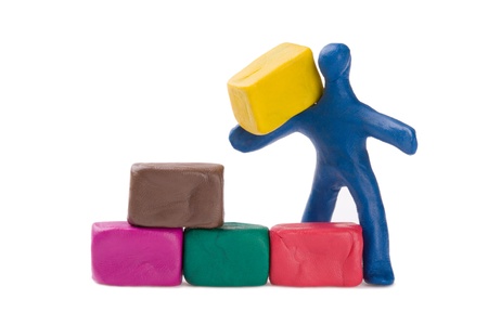 Plasticine little bricklayer building a brick wall. の写真素材