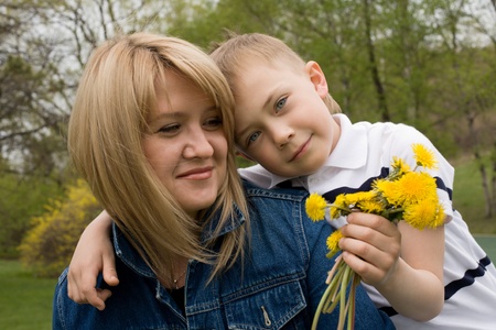 Mother and son. In his hand the boy flower dandelion.の写真素材