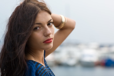 Beautiful girl on the waterfront in Vladivostok, Russia. Evening.の写真素材