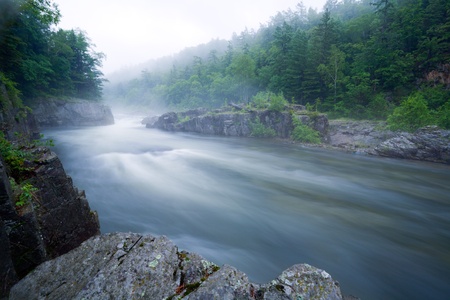 The mountain river. Above water the fog is laid. In the sky haze.evening.