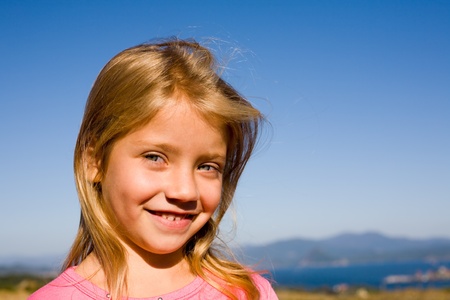 The smiling girl on a background of the nature.の写真素材