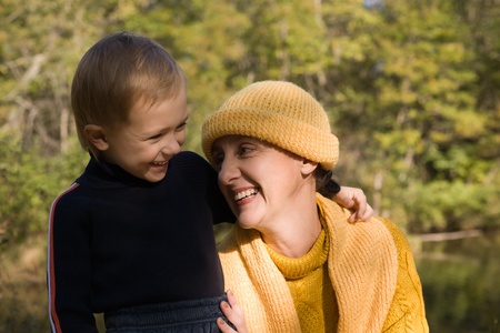 Joyful grandmother and the grandson on a background of a wood and the river.の写真素材
