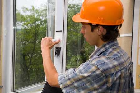 Building inspector checks quality of installation of new windows.の写真素材
