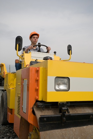 Worker operates a steamroller.