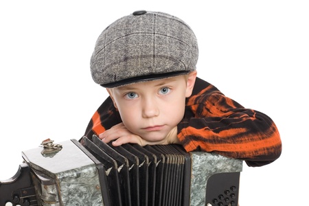Boy wearing a cap with accordion. Isolated jn white.の写真素材