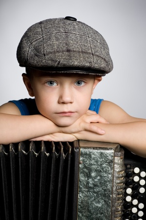 Portrait of serious boy with accordion.の写真素材
