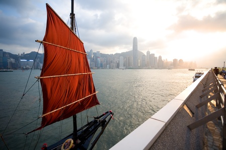 Sailing boat stands at the waterfront of Hong Kong at sunset. September, 2011.の写真素材
