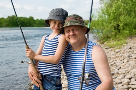 Happy grandfather and grandson fishing.の写真素材