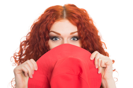 Beautiful red haired girl hid behind her hat の写真素材