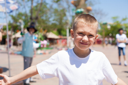 Cute boy at an amusement park.の写真素材