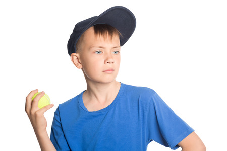 Serious boy holding a tennis ball の写真素材