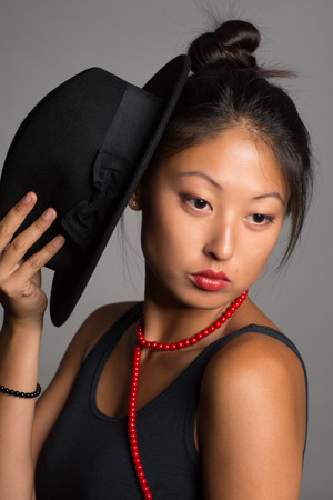 Fashionable young woman of Asian on a gray background.の写真素材
