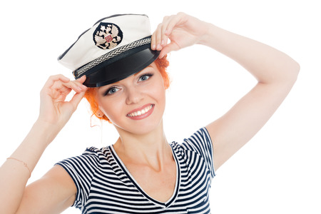 Happy girl sailor with red hair on a white background. On his cap emblem of Russia.の写真素材