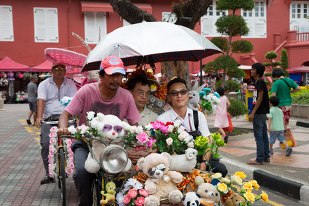 MALACCA, MALAYSIA - CIRCA JANUARY, 2015: Tourists traveling in a rickshaw at the Dutch Square in Malacca. Malacca was included in the list of UNESCO World Heritage Sites in 2008.のeditorial素材