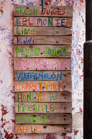Assortment of soft drinks and juices in the decorative design of the sign of the small wooden boards.の写真素材