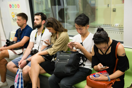 SINGAPORE - CIRCA FEBRUARY, 2015: Passengers traveling on the subway in Singapore. The MRT network encompasses 152.9 kilometres of route, with 113 stations in operation.のeditorial素材