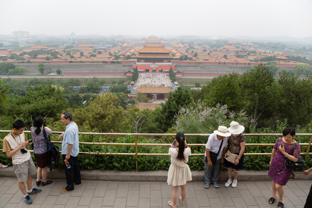 BEIJING - CIRCA JUNE , 2015: Tourists on a viewing platform in the Jingshan park. Observation desk Jingshan Park is the highest point of the old Beijing, it offers view of the Imperial Forbidden Cityのeditorial素材