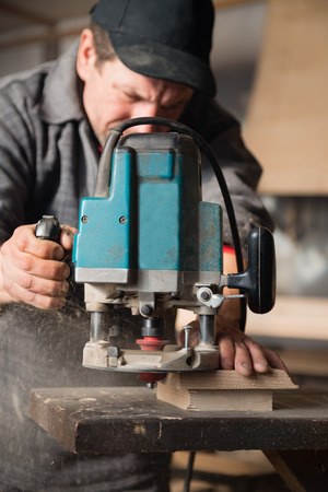 Carpenter working of manual milling machine in the carpentry workshopの写真素材