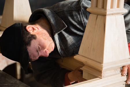 Carpenter checks to make furniture in the carpentry workshopの写真素材