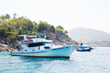 PHI PHI ISLANDS, THAILAND - CIRCA FEBRUARY, 2015: Cruise boat with tourists on the shore of the island of Phi Phi Doh in the Andaman Sea. Island is very popular with tourists from all over the worldのeditorial素材