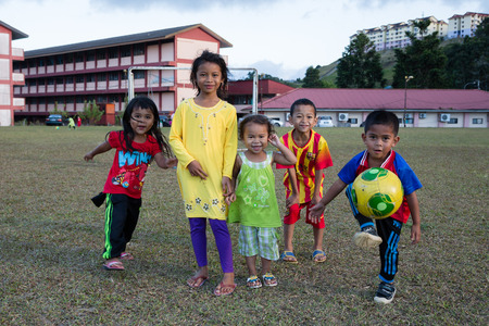 TANAH RATA, MALAYSIA - CIRCA FEBRUARY, 2015: Joyful playful young children at a public stadium in Tanah Rata, Cameron Highlands. Children play a lot of sports games at the stadium.のeditorial素材