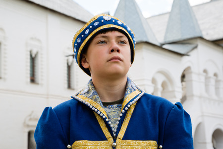 Portrait boy in national russian suit Middle Ages on the territory Kremlin Rostov Great (Veliky)の写真素材