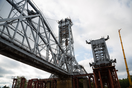 Under construction bridge on the river in the north of Russiaの写真素材