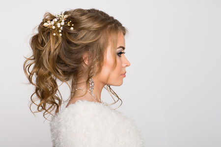 Young girl with beautiful hairstyle on a gray backgroundの写真素材