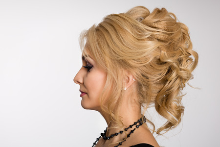 Profile of young blonde girl with fashionable hairstyleの写真素材