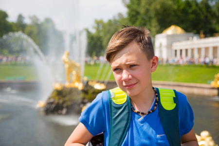 Teenager on a background of a fountain in St. Petersburg in Russiaの写真素材