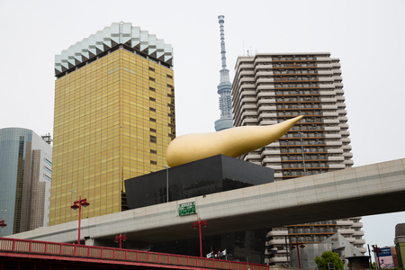 TOKYO - CIRCA MAY, 2017: Building-torch of the famous Japanese beer company Asahi in Asakusa on the banks of the Sumida River in Tokyo. Sculpture on the roof is depicted as a torch.のeditorial素材