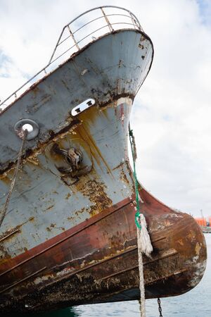 Bow of an old abandoned ship with an anchor. Environmental pollution.の写真素材