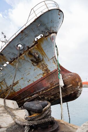 Bow of an old abandoned ship hangs over the sea. Environmental pollution.の写真素材