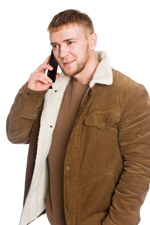 Young European man talking on a smartphone. Isolated on white.の写真素材