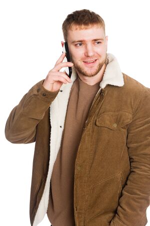 Young European man talking on a smartphone. Isolated on white.の写真素材