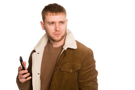 Young handsome man talking on a smartphone. Isolated on white.の写真素材