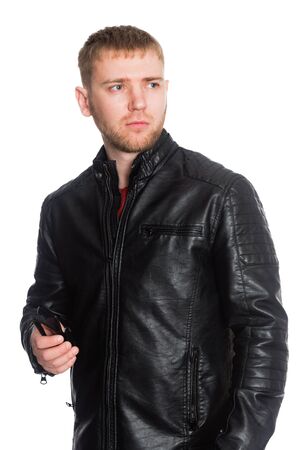 Young European man with a beard in a black jacket. Isolated on a white.の写真素材