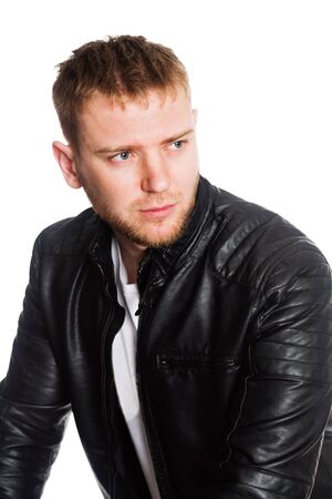 Young European man with a beard in a black jacket. Isolated on a white.の写真素材
