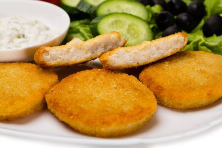 Grilled fish cutlet with vegetables. Isolated on white.の写真素材
