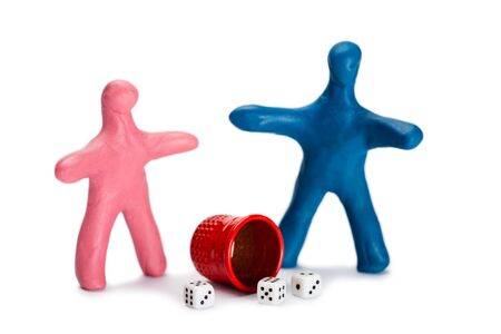 Plasticine small people play dice isolated on whiteの写真素材