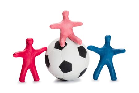 Plasticine small people soccer players with soccer ball isolated on whiteの写真素材